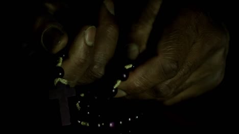 man-praying-to-god-with-hands-together-on-black-background-with-people-stock-video