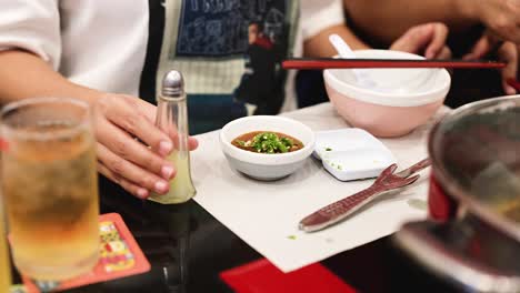 adding ingredients to a sauce in bangkok