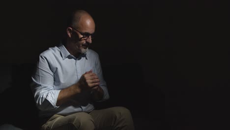 Depressed-Mature-Man-Struggling-With-Mental-Health-Sitting-In-Darkness-On-Sofa-With-Low-Key-Lighting-8