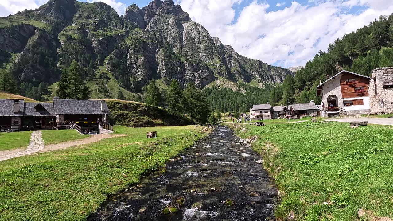 Crampiolo, a scenic alpine hamlet in Alpe Devero Natural Park, Piedmont, Italy, surrounded by rugged mountains and lush meadows.
