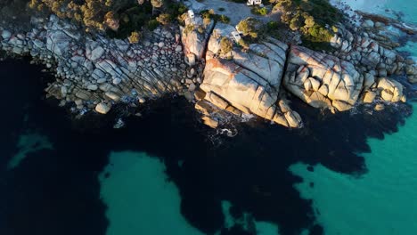 transparent sea and rocky cliffs at bay of fires, tasmania in australia