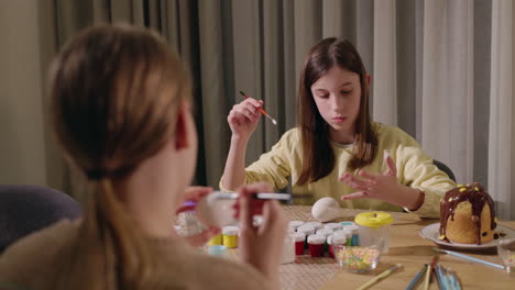 sisters painting easter eggs