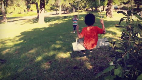 Happy-little-boy-on-a-swing-