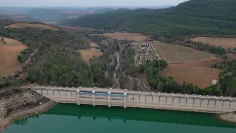 San-ponce-reservoir-in-cardona,-barcelona-surrounded-by-lush-green-hills,-aerial-view