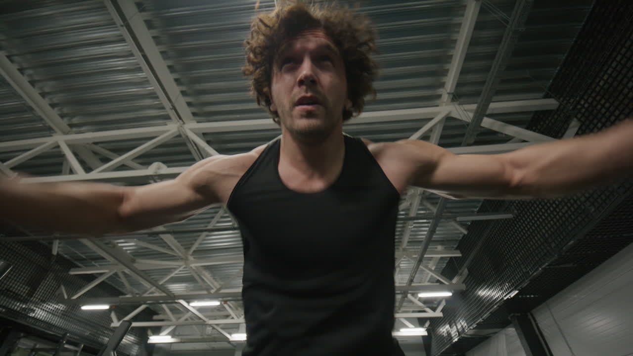 Strong Man Performing Battle Rope Power Slams during Gym Workout