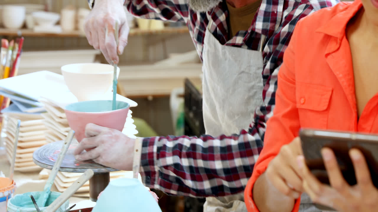 디지털 태블릿 4k 를 사용하는 여성 도자기 제작자