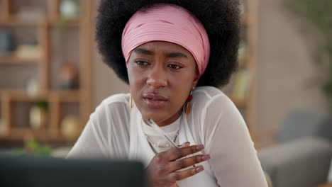 african american woman concentrating on work at her laptop