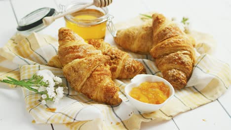 condiments and croissants lying on towel