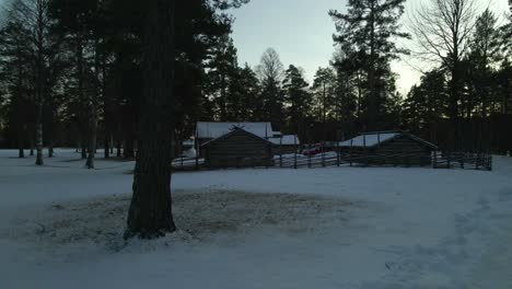 log cabin and fence, winter vacation home, dolly left