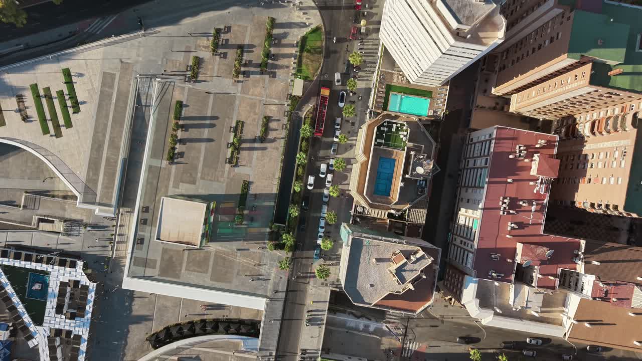 Malaga city from an aerial view bustling streets, cars, and people moving through the lively urban landscape under the southern sun