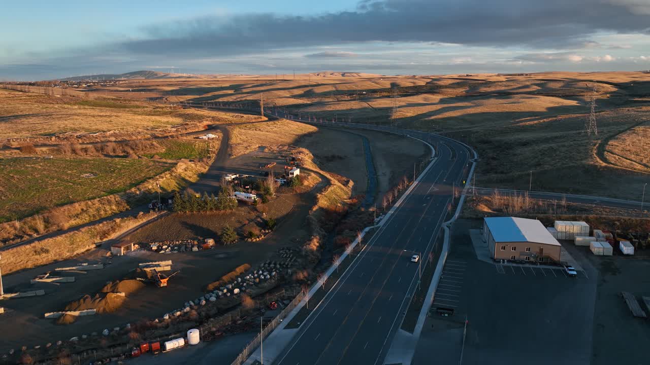 Aerial view of lone car driving through Eastern Washington's farming community