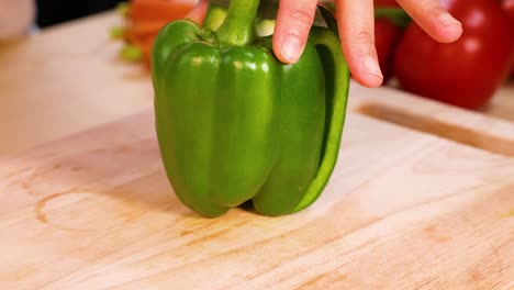 hands preparing bell pepper for cooking