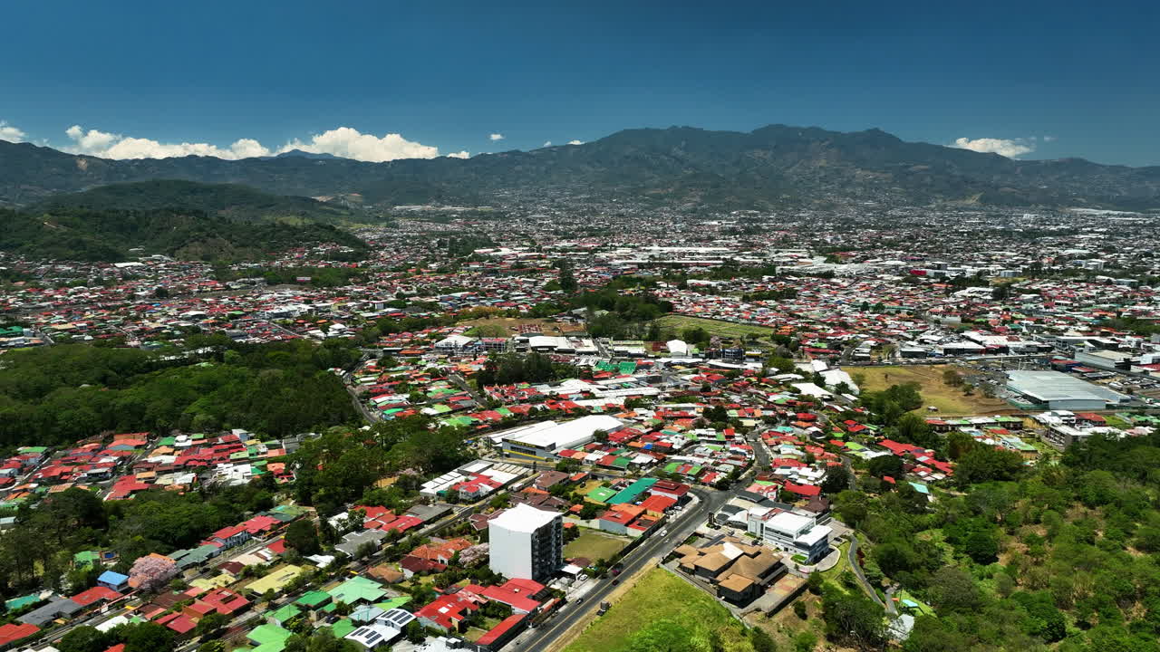 Establishing drone shot overlooking the cityscape of San Jose, sunny Costa Rica
