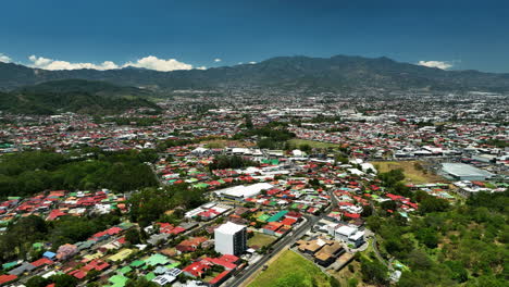 establishing drone shot overlooking the cityscape of san jose, sunny costa rica