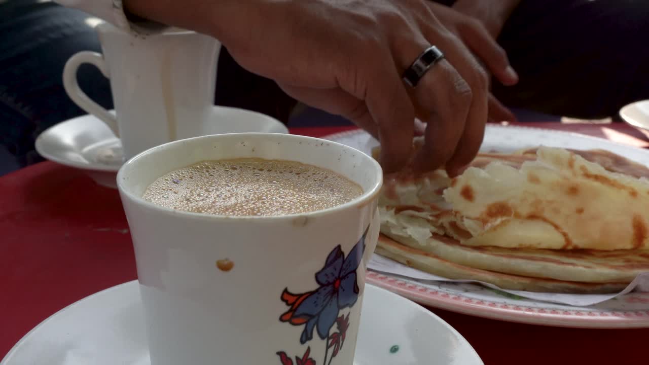 Enjoying a cup of chai with paratha