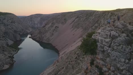 Drone-fly-above-Zrmanja-river-canyon-during-golden-hour,-colourful-sky-and-weak-autumn-sun