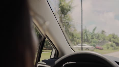 Back-view-of-a-girl-with-glasses-driving