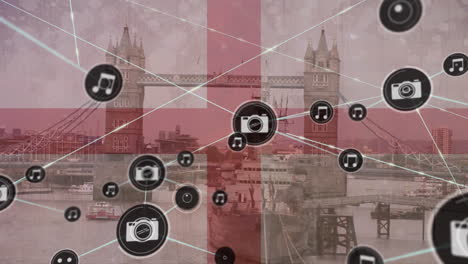 animación de una red de iconos digitales sobre la bandera de inglaterra en el puente de londres.