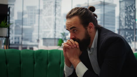Vertical Video Male corporate leader buries his face in his hands due to frustration