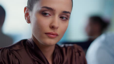 Pensive-businesswoman-sitting-at-workplace.-Serious-female-worker-looking-away