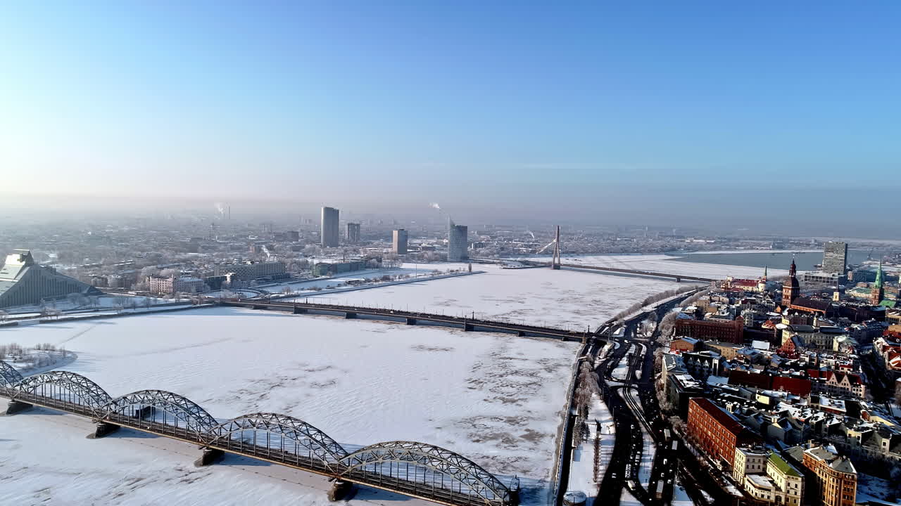 Aerial view of riga - bridges crossing the frozen daugava river, latvia ...