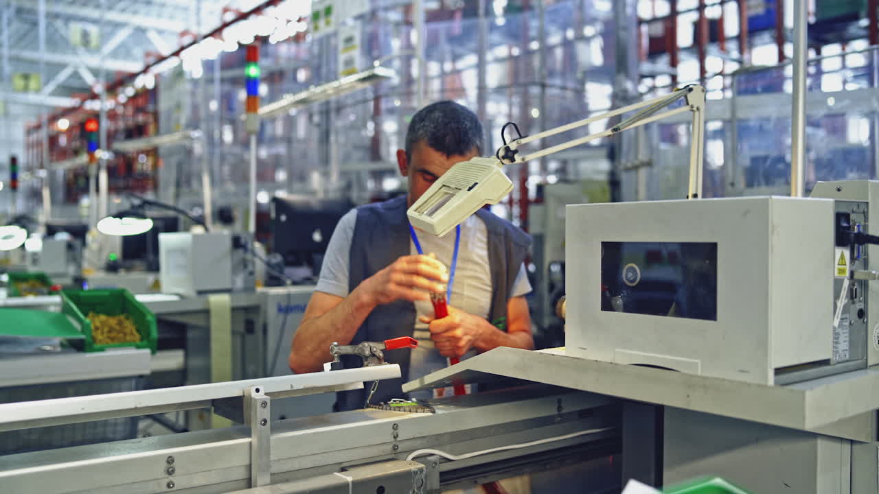 Handsome factory worker. Factory worker working in industrial building indoor