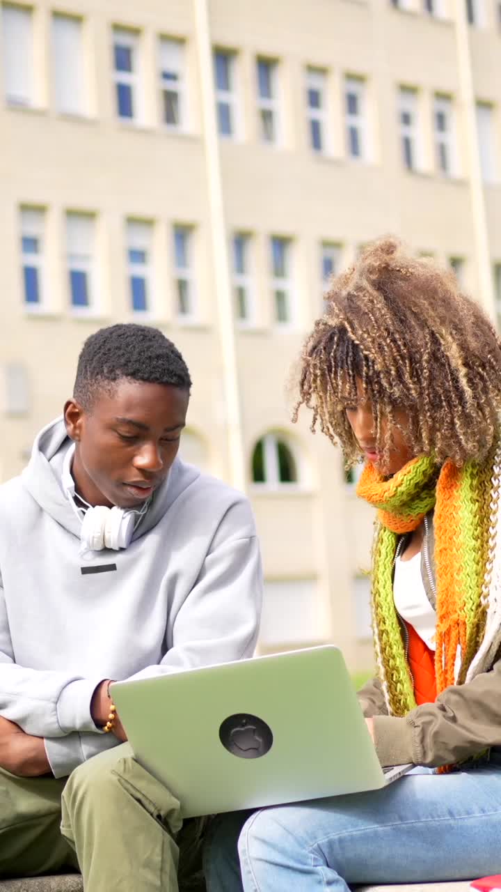 Students Collaborating on Laptop at University