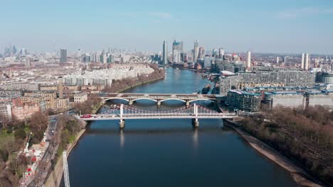 circling drone shot over london river thames at battersea power station chelsea bridge