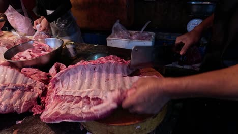 expert hands slicing through large cuts of meat.