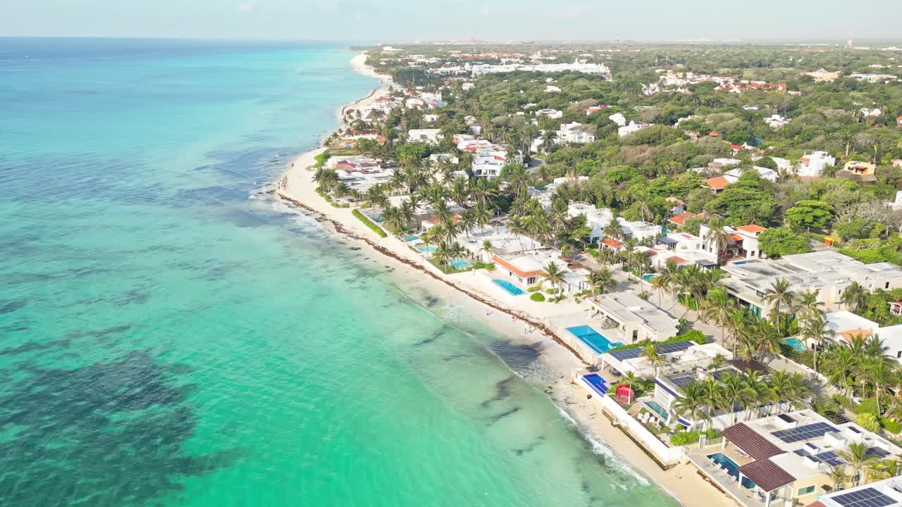 Tropical coastline homes in playa del carmen, mexico on a sunny day, aerial view