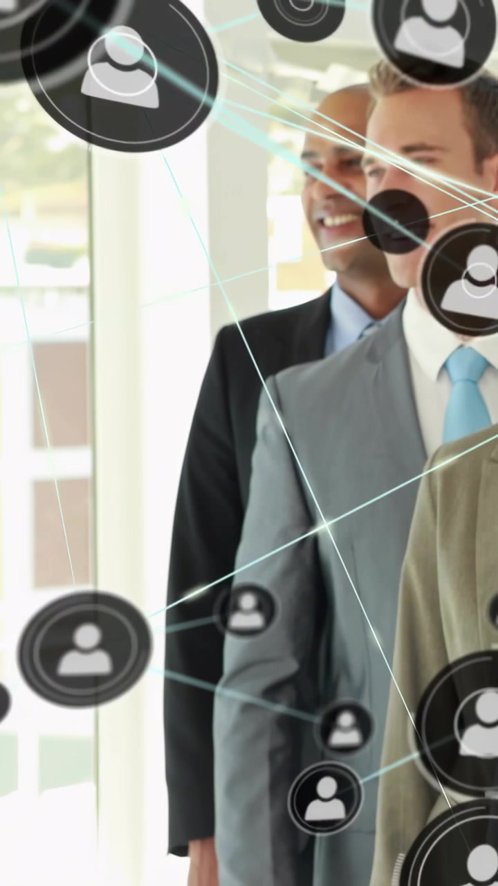 Vertical video: Camera panning left execs posing by glass, net icons floating over faces for promo
