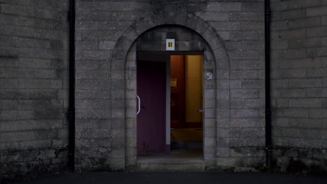 Open doorway of cinder block building on a dark spooky evening