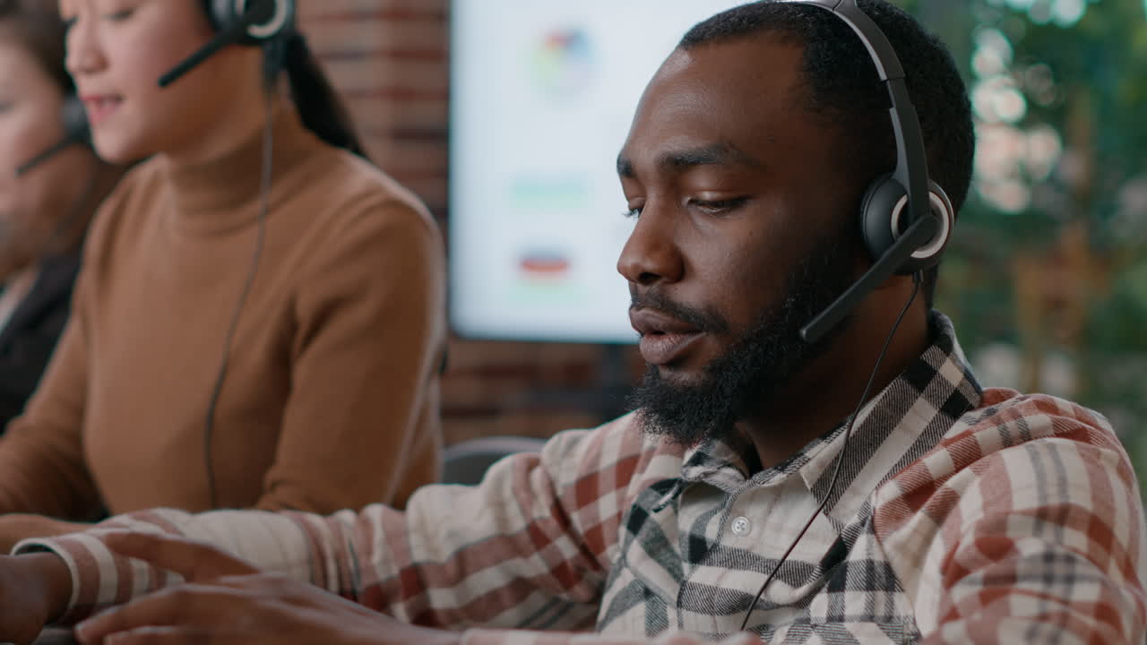 Young man answering telework call at customer service job