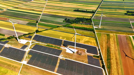 fields with solar panels installed. aerial perspective on the wind turbines produce energy in the countryside