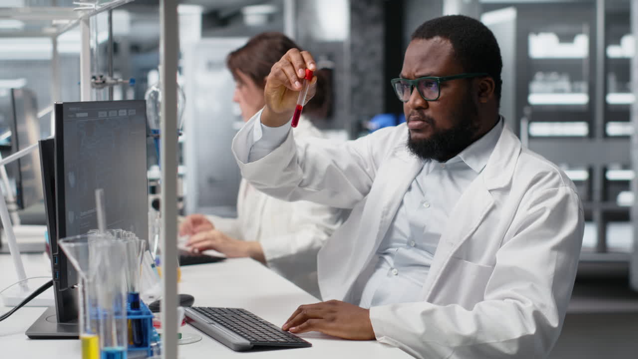 Vertical video Scientist in laboratory interprets clinical blood values on computer
