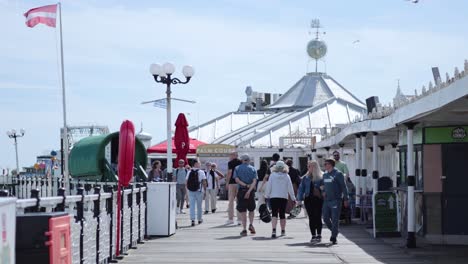 people strolling along brighton pier