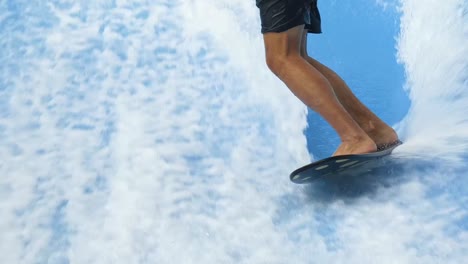 person surfing in an indoor wave pool