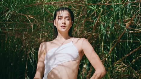 tropical woman resting summer sunlight portrait. swimsuit model at bamboo nature