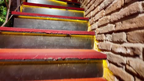 illuminated spiral staircase with red carpet and decorative vases