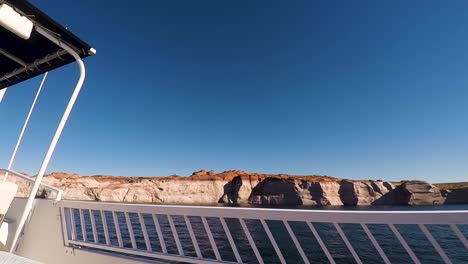 View-from-a-houseboat-as-it-travels-down-the-shoreline-of-Lake-Powell,-Page-Arizona