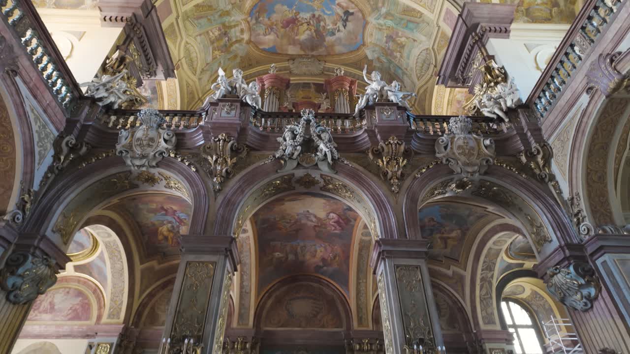 A breathtaking view of the Baroque-style painted ceiling in Wroclaw University's Church of the Blessed Name of Jesus, showcasing intricate religious artwork and opulent architecture.
