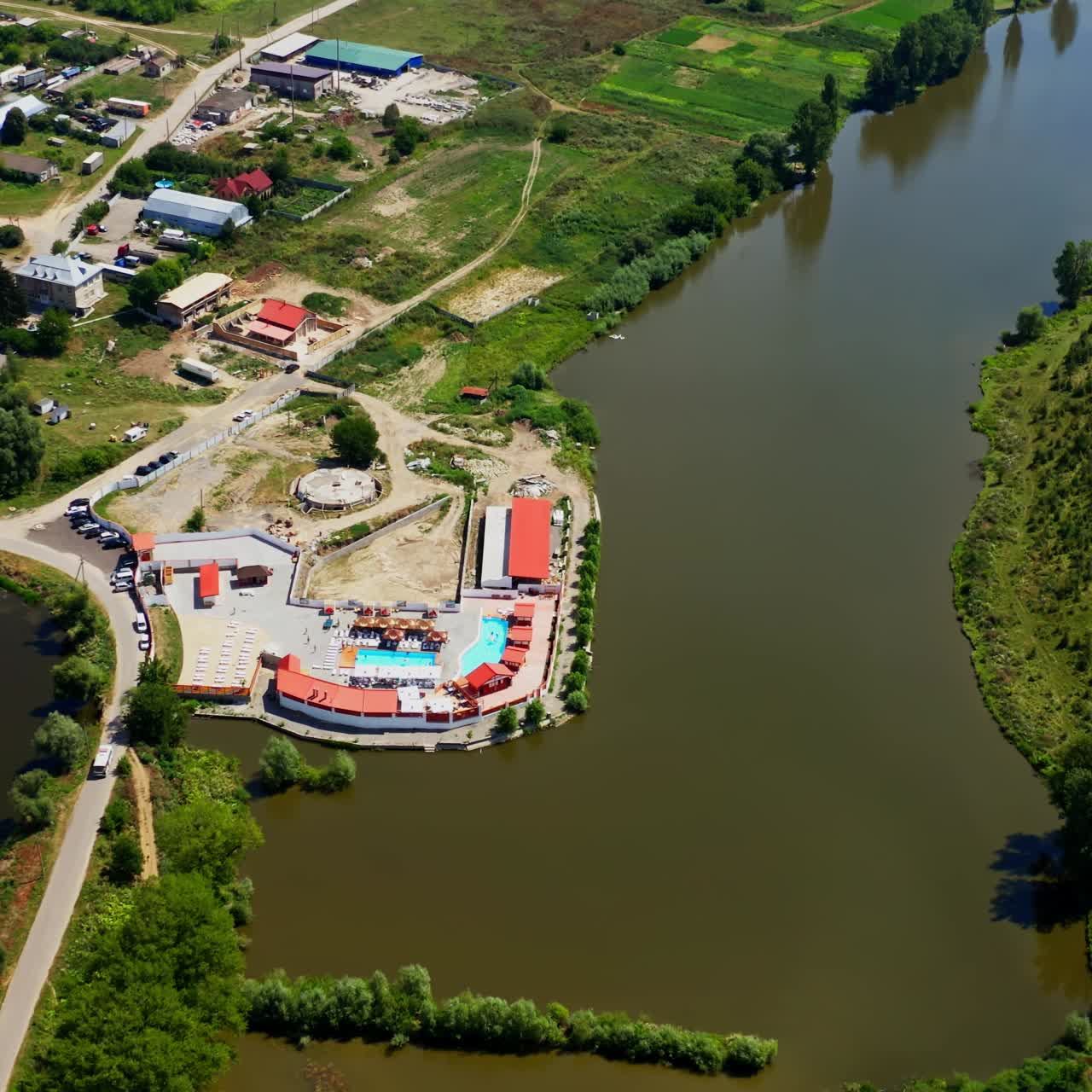 Countryside in summer time. Small town and resort place near the lake. Panoramic view of small village houses among nature. Aerial view.