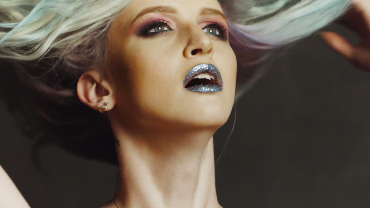 Stunning studio blonde. Beautiful young blonde woman with hand in hair