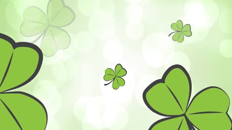 animation of clover leaves falling over white spot lights on green background