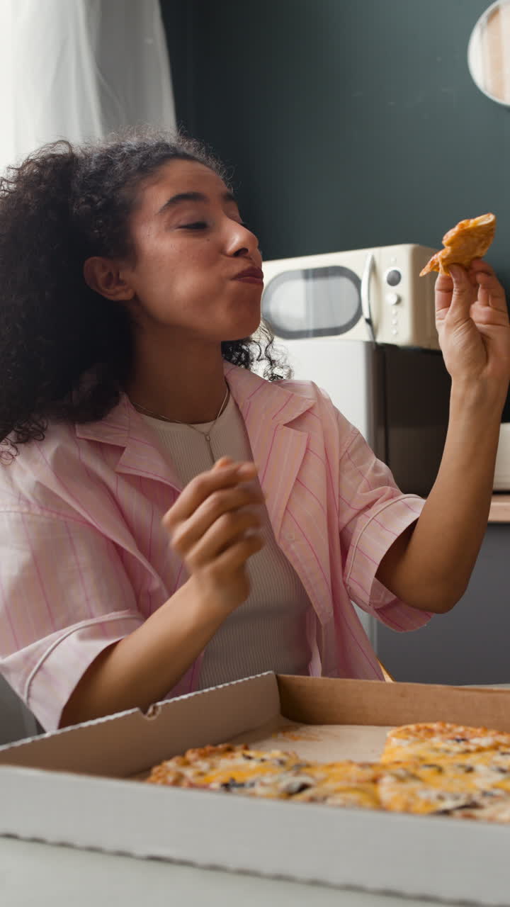 Young Woman Enjoying Pizza at Home