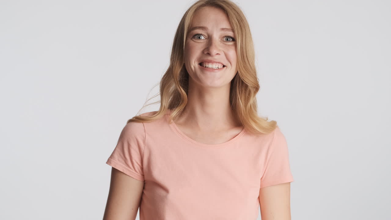 Caucasian woman laughing on camera.