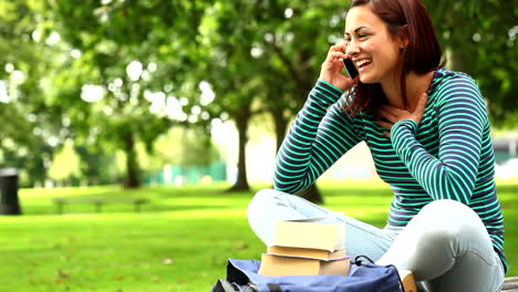 Bonito-Estudiante-Hablando-Por-Teléfono-En-El-Césped