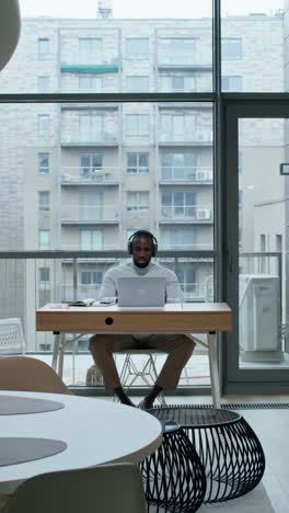 man working on laptop in modern office space