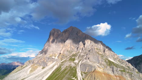 aerial view orbiting steep peitlerkofel south tyrol dolomites rocky mountain summit against blue cloudy sky