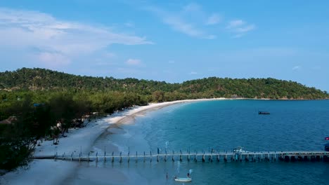 Aerial-side-profile-of-wooden-pier-at-sunset-on-4k-Beach,-Kong-Rong,-Cambodia